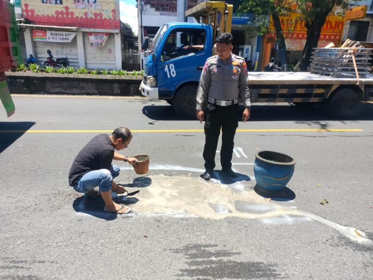 Peduli Keselamatan Masyarakat, Polisi di Malang Tambal Jalan Berlubang Bersama Warga